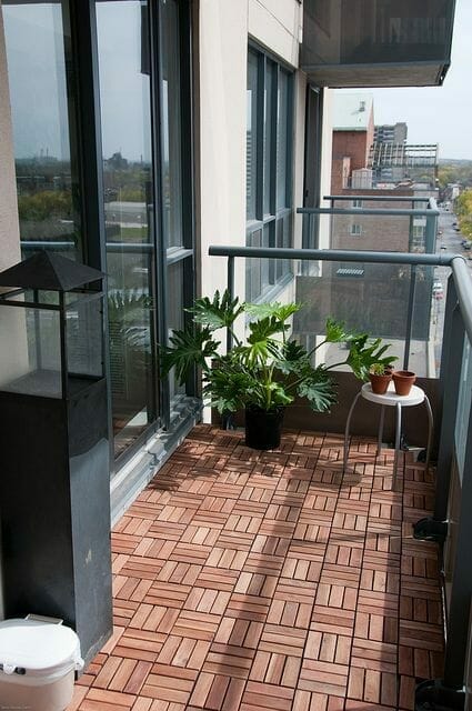 drewniana podłoga na balkonie, szklane balustrady, w bloku