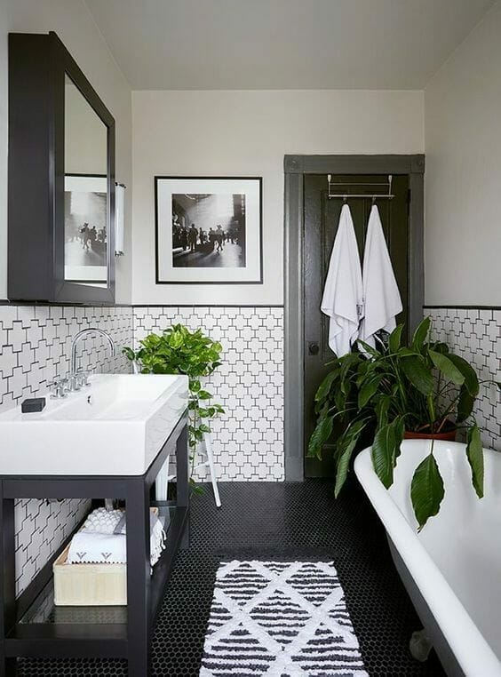 biała łazienka z czarnymi dodatkami i kwiaty do łazienki